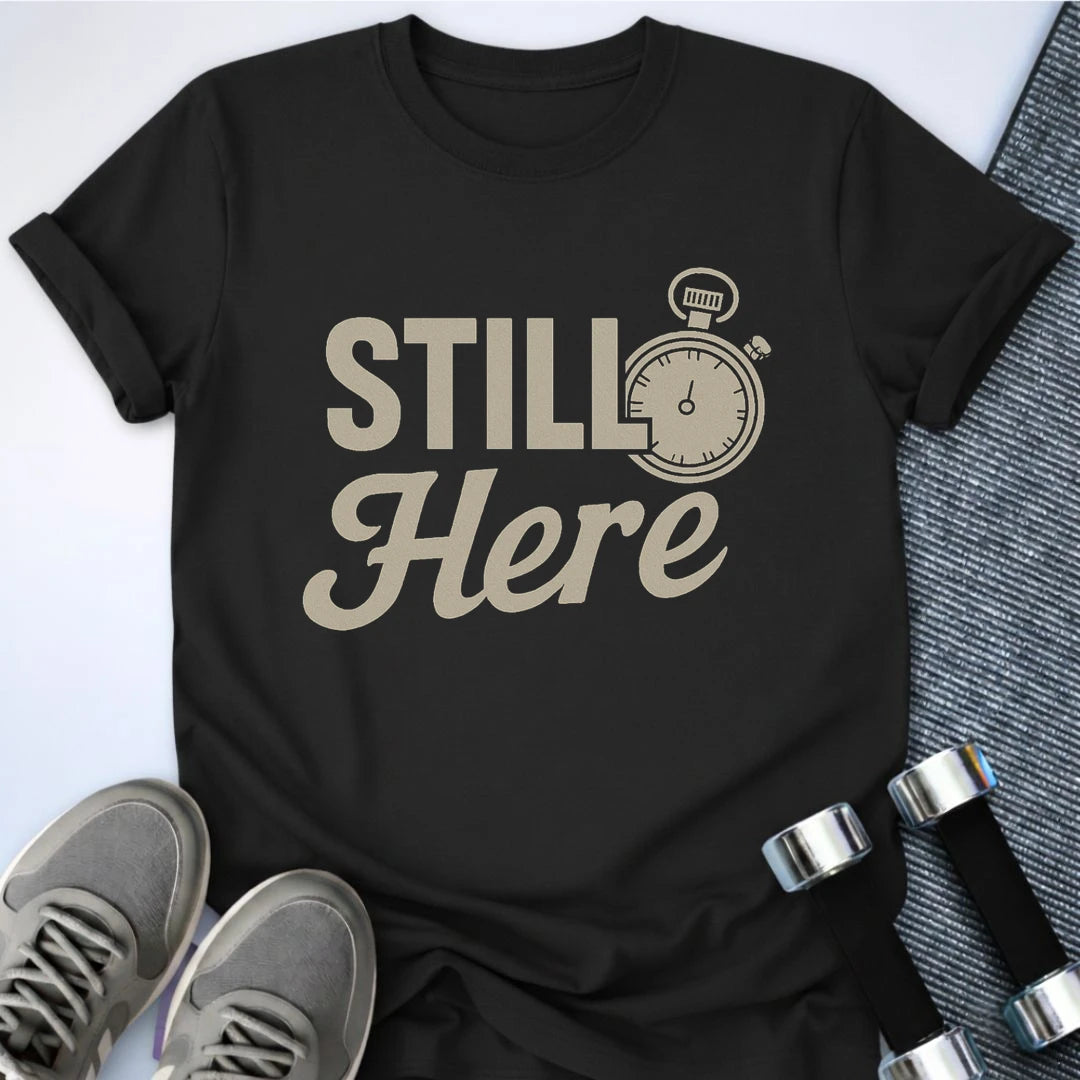 Printify T-Shirt Black / S She's Still Here T-Shirt